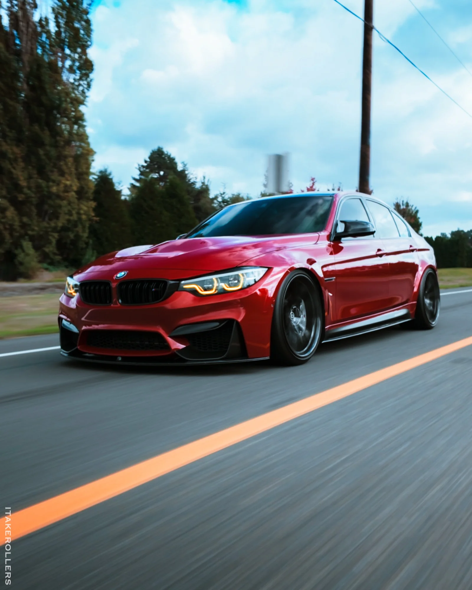 Red BMW M3 rolling side shot